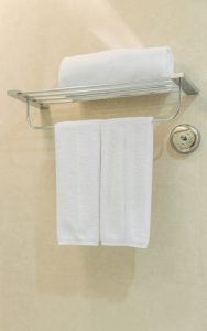 clean-white-towel-on-a-hanger-prepared-in-bathroom_1232-3338